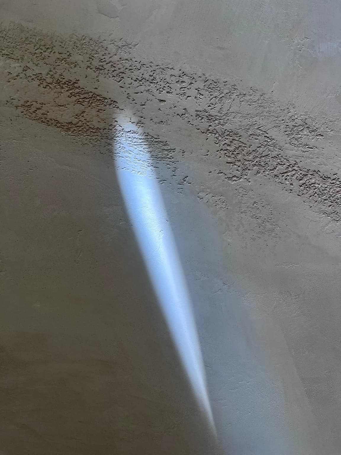 Beam of light across textured plaster